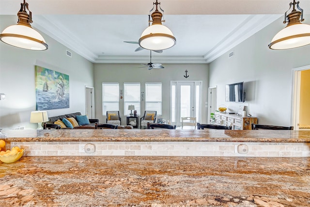 interior space featuring ceiling fan and crown molding