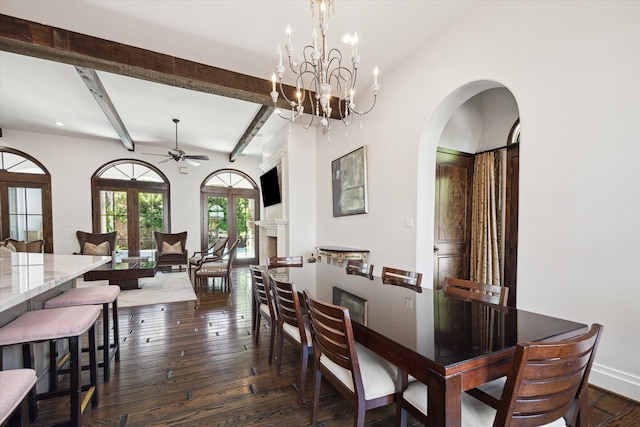 dining space featuring beamed ceiling, french doors, ceiling fan with notable chandelier, and dark wood-type flooring