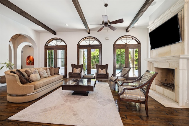 living room featuring french doors, wood-type flooring, ceiling fan, and a fireplace