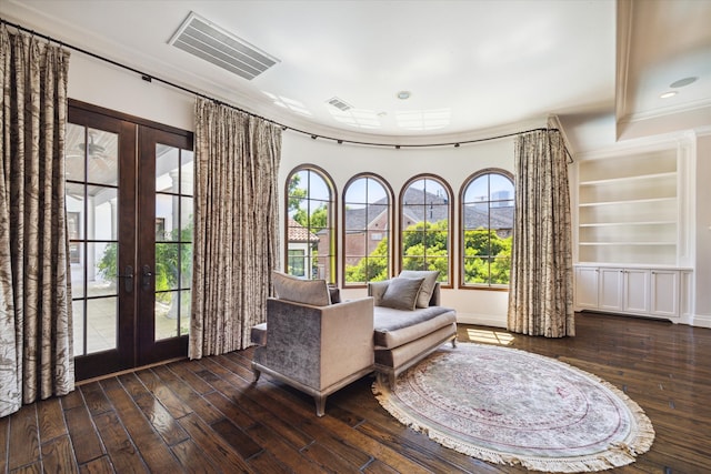 unfurnished room with french doors, crown molding, dark hardwood / wood-style floors, and built in shelves