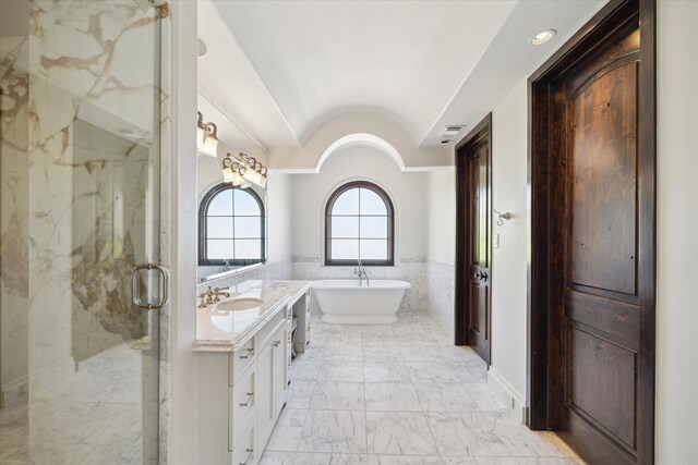 bathroom with oversized vanity, plus walk in shower, and tile floors