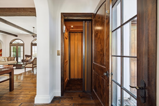 hall featuring beamed ceiling and dark hardwood / wood-style flooring