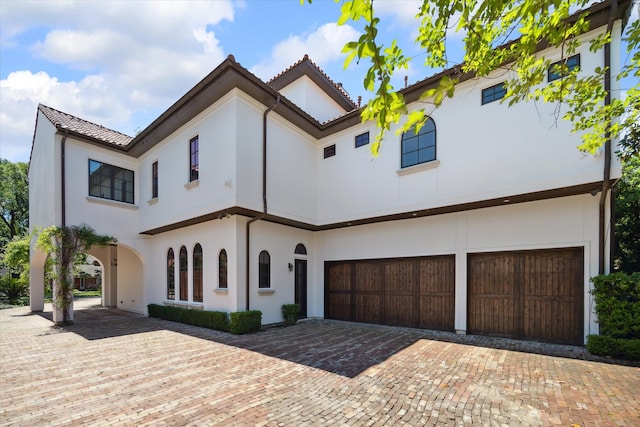 mediterranean / spanish home featuring a garage