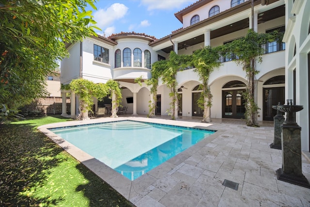 view of swimming pool featuring french doors and a patio