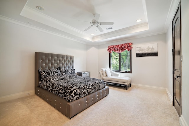 bedroom featuring crown molding, ceiling fan, carpet floors, and a tray ceiling