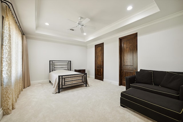 carpeted bedroom featuring ornamental molding, ceiling fan, and a raised ceiling