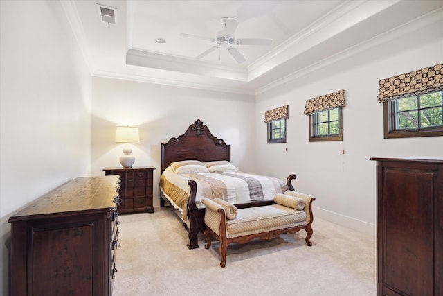 bedroom featuring ornamental molding, light colored carpet, ceiling fan, and a raised ceiling