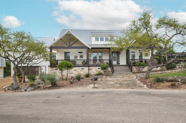 view of front of home with covered porch and a garage