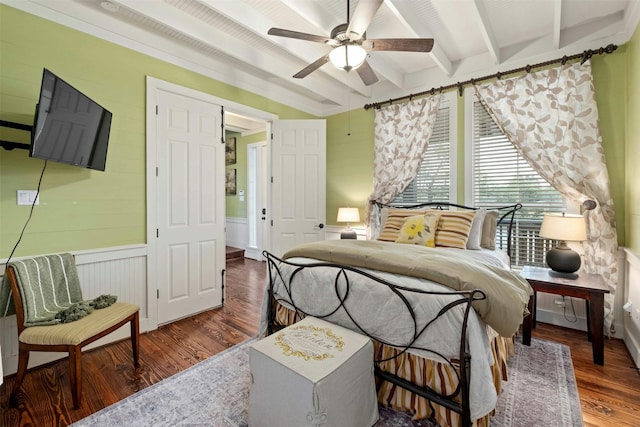 bedroom featuring hardwood / wood-style floors, ceiling fan, and beam ceiling