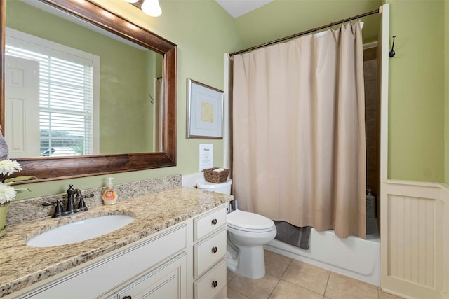 full bathroom featuring tile floors, shower / tub combo, vanity with extensive cabinet space, and toilet