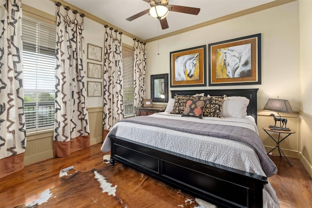 bedroom with wood-type flooring, ceiling fan, and ornamental molding