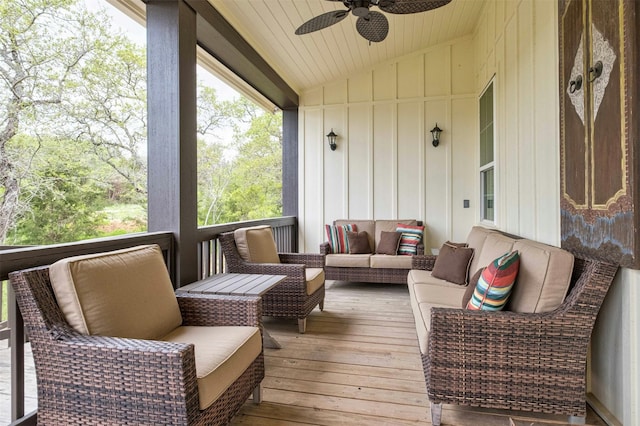 wooden terrace with ceiling fan and an outdoor hangout area