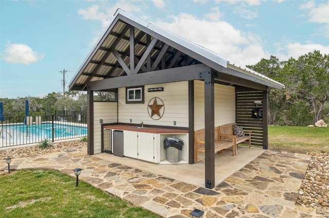 view of terrace featuring a swimming pool with hot tub and a gazebo