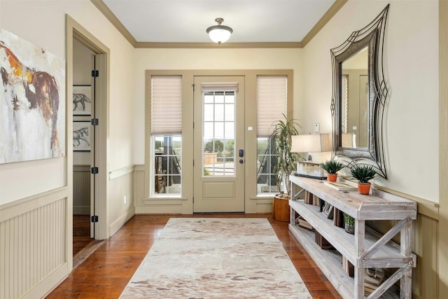 doorway with hardwood / wood-style flooring and ornamental molding