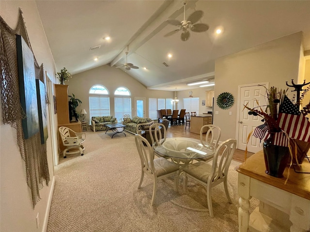 carpeted dining space with lofted ceiling with beams and ceiling fan