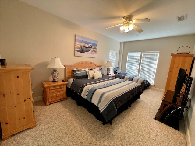 bedroom featuring light colored carpet and ceiling fan