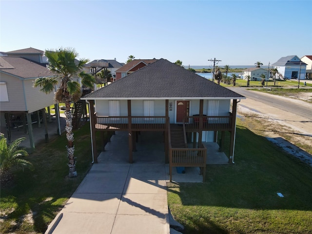 view of front of house with a front yard and a carport