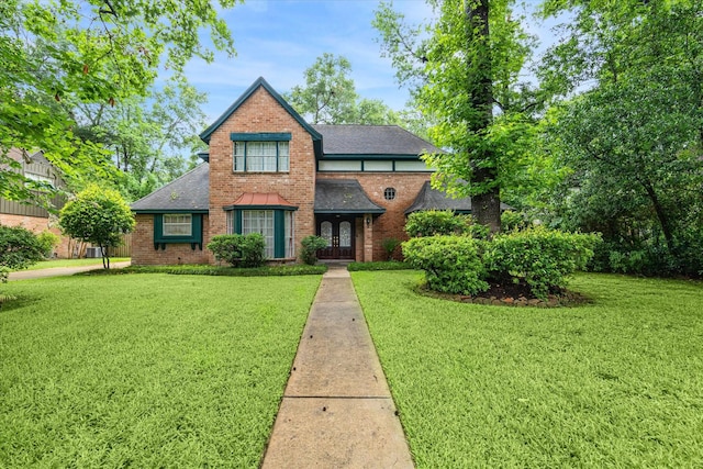 view of front of property with a front yard and french doors