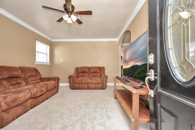 carpeted living room featuring ornamental molding and ceiling fan