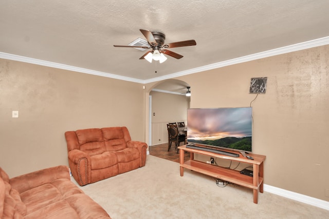 carpeted living room with a textured ceiling, ceiling fan, and crown molding