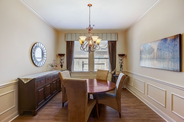 dining room with crown molding, dark wood-type flooring, and a chandelier