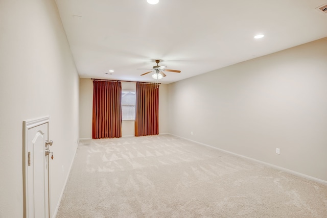 carpeted spare room featuring ceiling fan