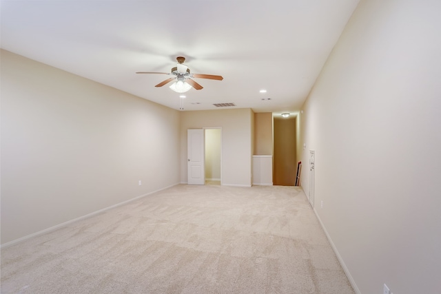 carpeted empty room featuring ceiling fan