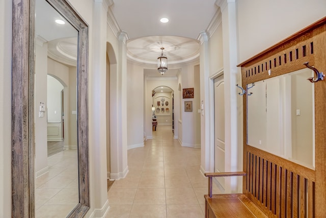 hall with light tile patterned floors and ornamental molding