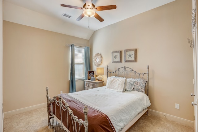 bedroom with ceiling fan, light colored carpet, and vaulted ceiling