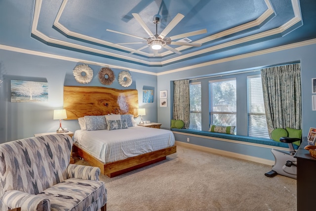 carpeted bedroom featuring a tray ceiling, ceiling fan, and ornamental molding