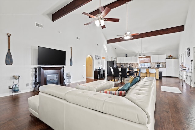 living room featuring high vaulted ceiling, ceiling fan, and dark hardwood / wood-style flooring