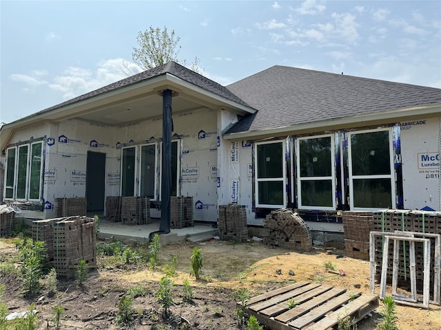 back of house with central air condition unit