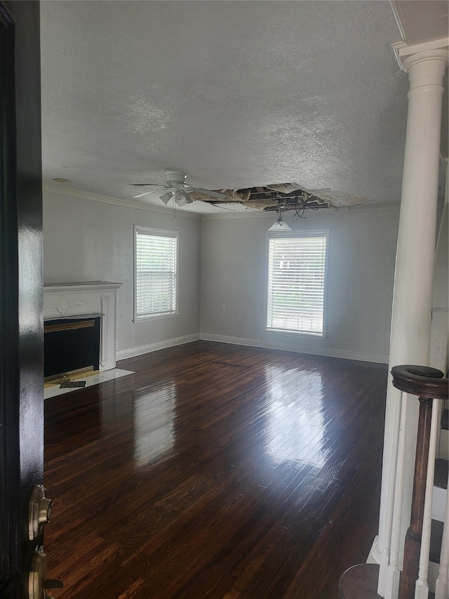 unfurnished living room with a textured ceiling, ceiling fan, hardwood / wood-style floors, and a fireplace