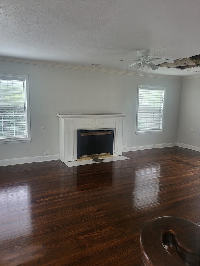 unfurnished living room featuring ornamental molding, dark hardwood / wood-style flooring, ceiling fan, and a textured ceiling