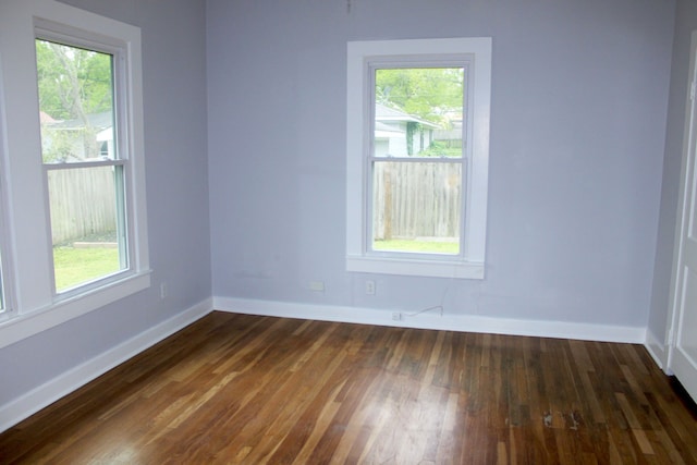 spare room with dark wood-type flooring