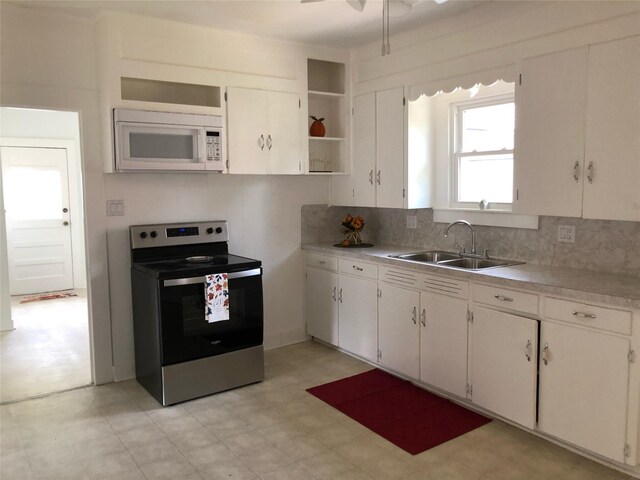 kitchen featuring stainless steel electric stove, white cabinetry, sink, ceiling fan, and tasteful backsplash