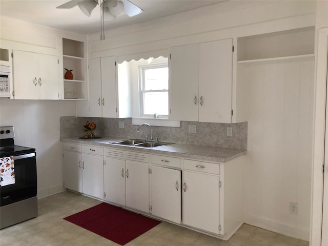 kitchen featuring electric stove, sink, ceiling fan, decorative backsplash, and white cabinets