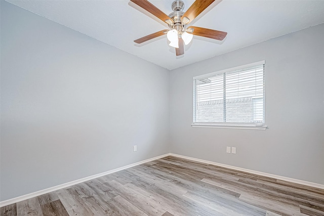 empty room with ceiling fan and light hardwood / wood-style floors