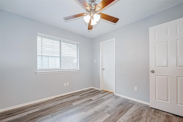 spare room with light wood-type flooring and ceiling fan