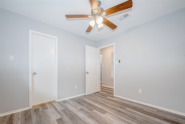 unfurnished bedroom with ceiling fan and light wood-type flooring