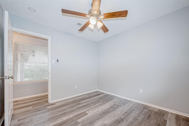 unfurnished room with ceiling fan and light wood-type flooring