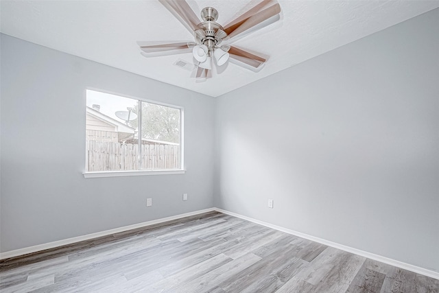 empty room featuring ceiling fan and light wood-type flooring