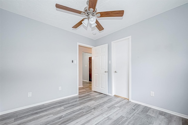 empty room with light wood-type flooring and ceiling fan