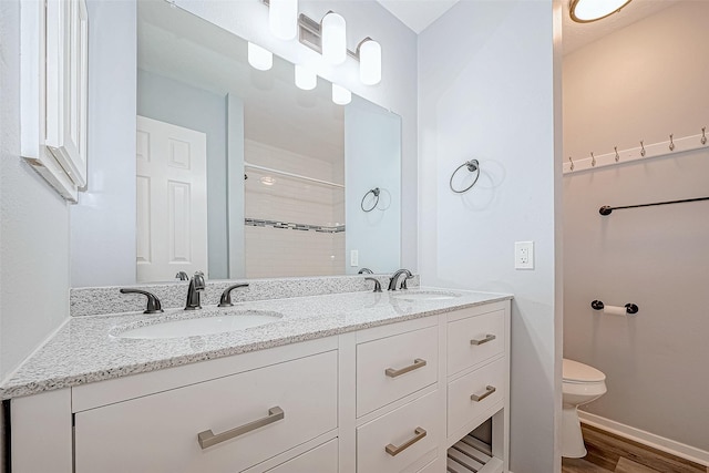 bathroom with vanity, hardwood / wood-style flooring, toilet, and walk in shower