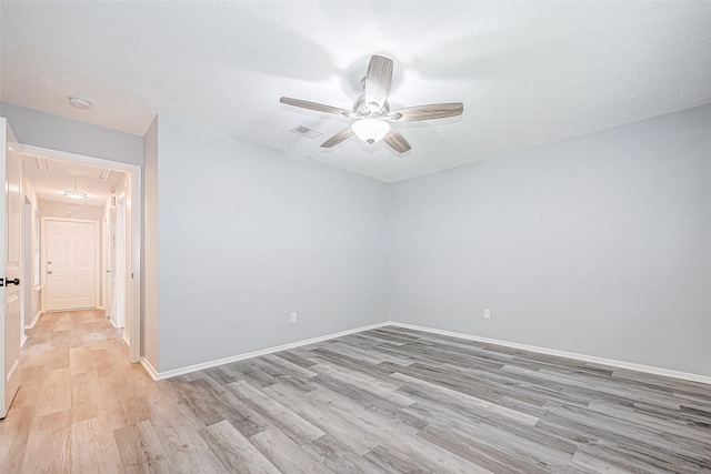 spare room with ceiling fan and light hardwood / wood-style floors