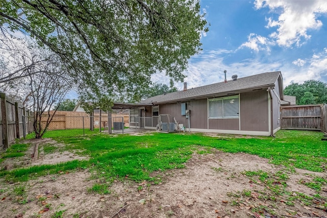 rear view of house with a yard