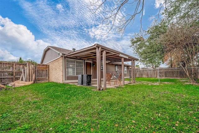 rear view of house featuring a lawn and a patio area