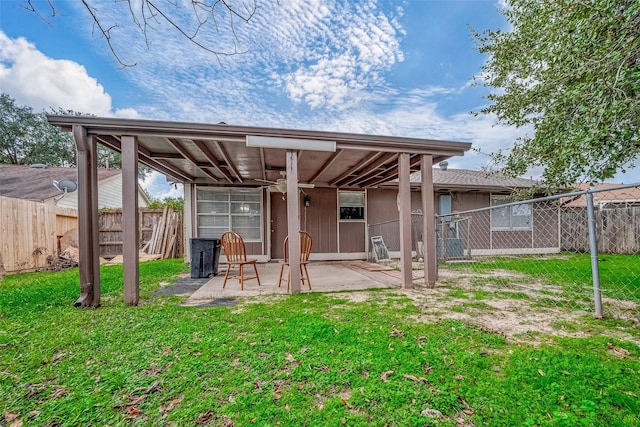 back of property featuring a yard and a patio