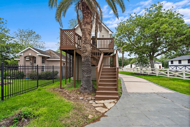 view of front of house with a wooden deck and a front yard