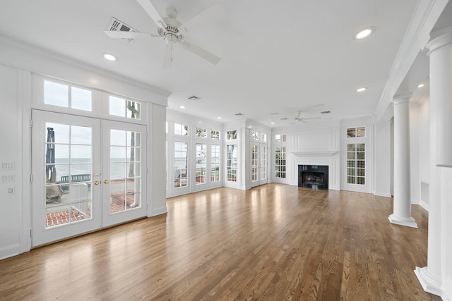 unfurnished living room featuring ceiling fan, crown molding, and hardwood / wood-style flooring